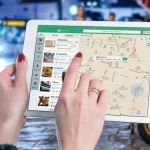Person using a tablet with a map on screen