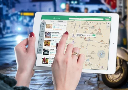 Person using a tablet with a map on screen