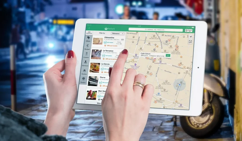Person using a tablet with a map on screen