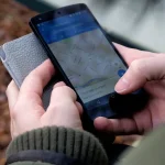 Hands using a phone with a map app open