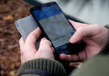Hands using a phone with a map app open