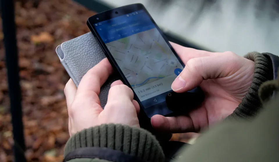 Hands using a phone with a map app open